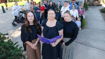 Petition organisers Bailey Krebser, Montana Farrall and Tara Buckley with concerned parents. Picture by Les Smith