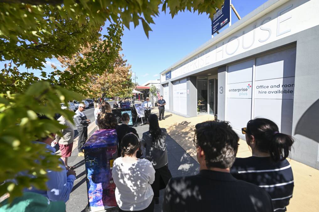 A healthy crowd gathered for the auction of the Enterprise House building on Stanley Street in Wodonga, which passed in for $2.21 million on Friday, April 12. Picture by Mark Jesser