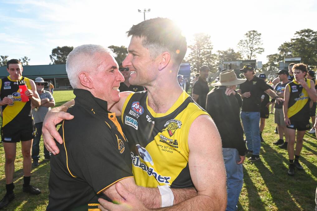 Joel Mackie embraces his father Rob Mackie after the grand final at Walbundrie. Picture by Mark Jesser