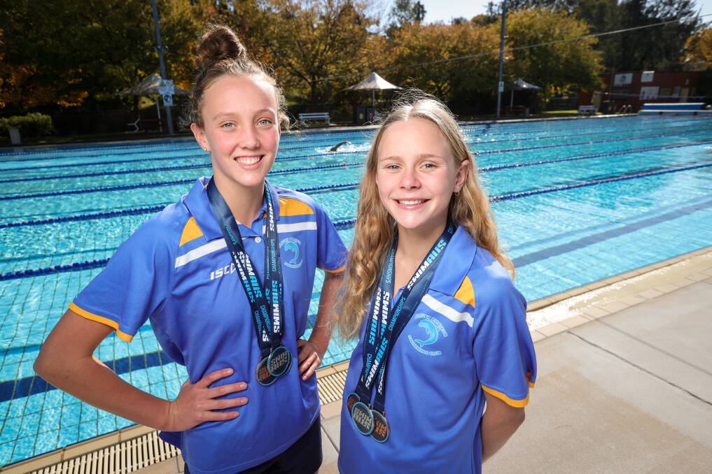 Albury Swim Club's Isabelle Rae and Sienna Toohey with the medals they won at the Australian Age Championships. Picture by James Wiltshire