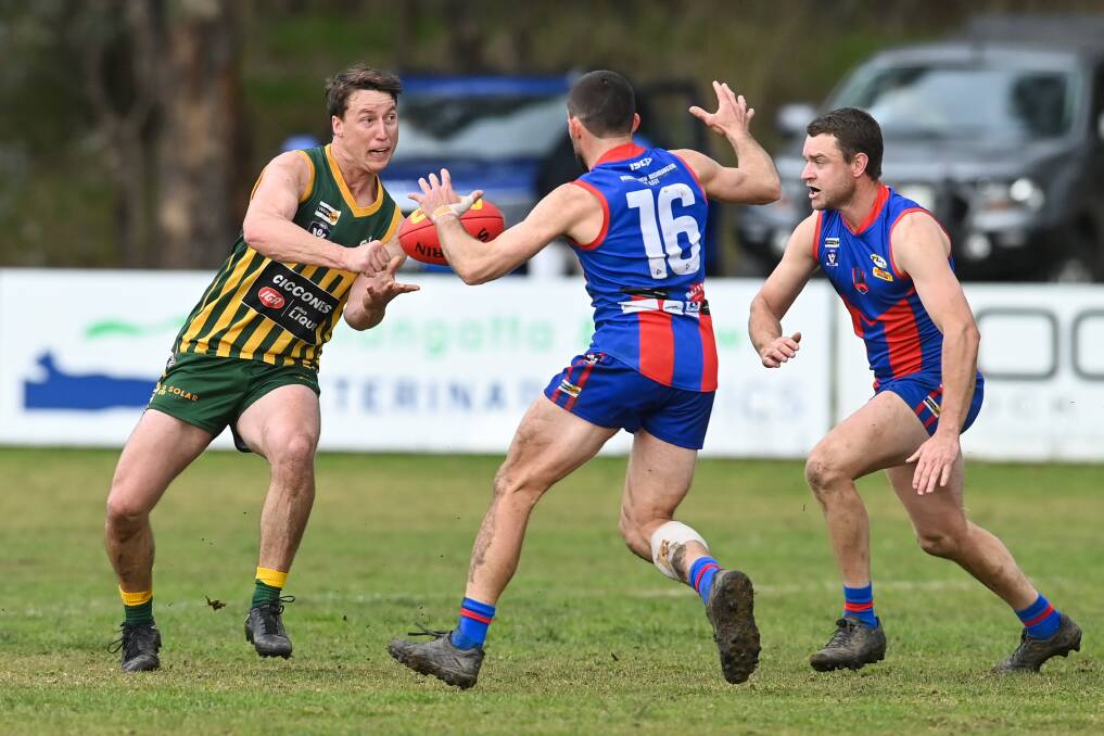 Luke Fraser is faced with Beechworth's Thomas Cartledge and Hamish Malsem. The Tallangatta captain finished the day with five goals. Picture by Mark Jesser