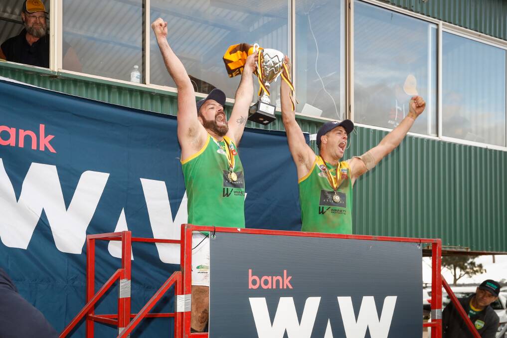 Coach Matt Sharp and captain Jacob Way lift the premiership cup. Picture by James Wiltshire