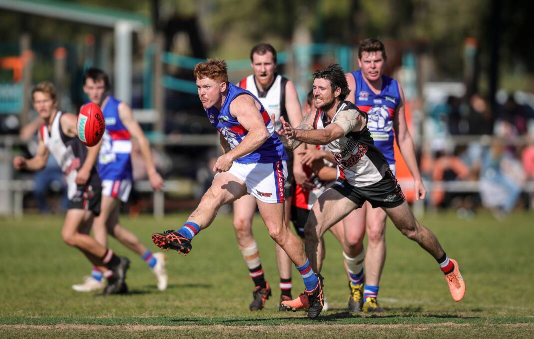Jack Avage gets his kick away under pressure during Jindera's elimination final against Brock-Burrum. The Bulldogs won a thriller by two points. Picture by James Wiltshire