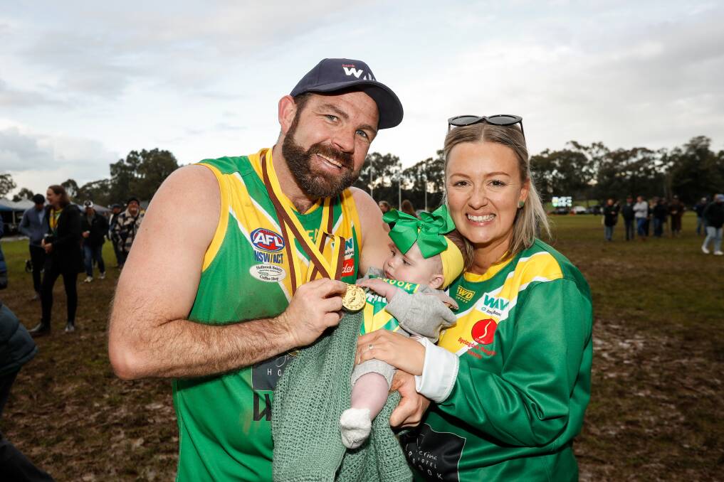 Holbrook coach Matt Sharp celebrates the first premiership of his career with wife Kayla and daughter Harper May. Picture by James Wiltshire