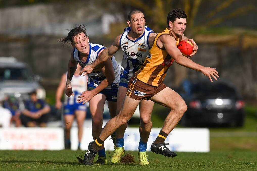 Chad Martin and David Price try to get to grips with Kiewa-Sandy Creek's Dillon Blaszczyk. Picture by Mark Jesser