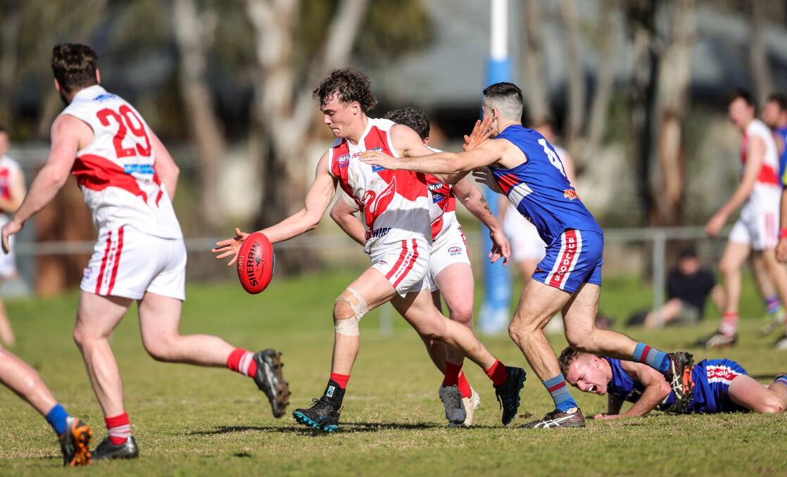 Ethan Muller gets his kick away for Henty. Picture by James Wiltshire