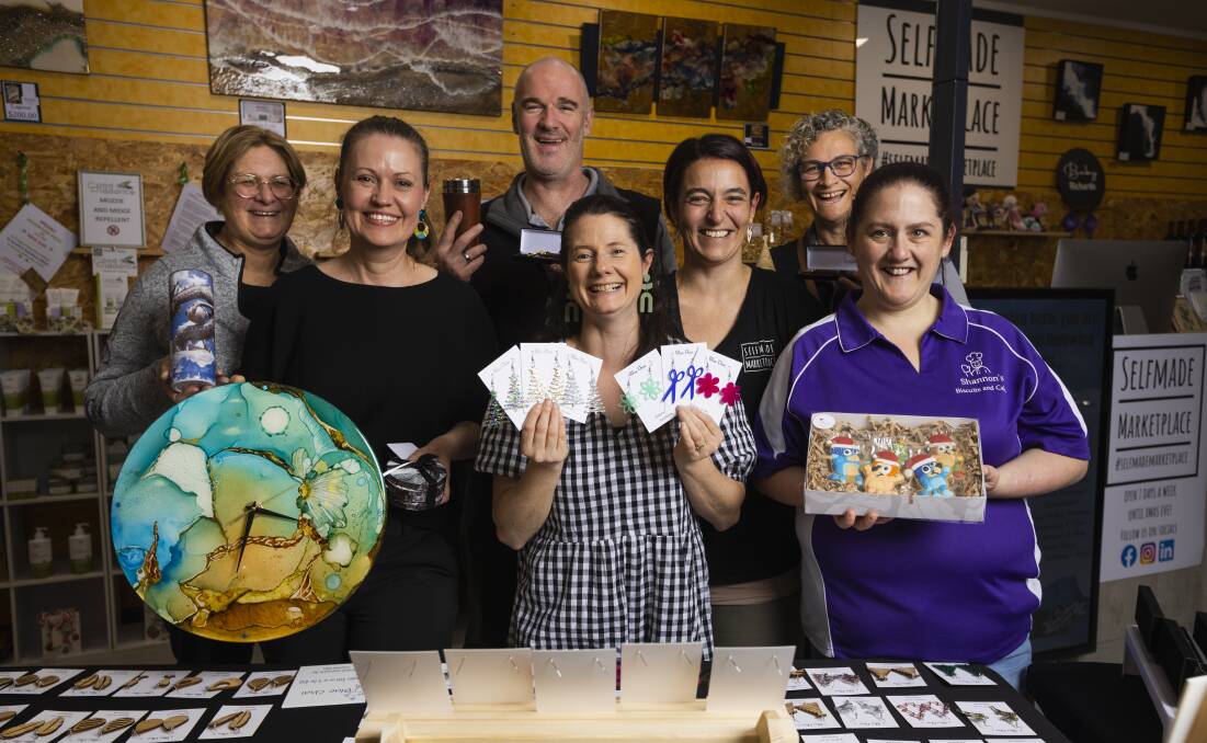Shiralee Allen, Kerrie Grant, Angus Lyons, Corrie Pierce, Bec Hay, Patricia Lyons and Shannon Dean welcome people and hope they get behind the storefront so it can stay beyond Christmas. Picture by Ash Smith