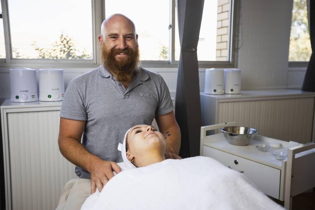 David Hobman is now working as a beautician at Endota Spa, he is giving beauty student Zoe Batten a face treatment. Picture by Ash Smith