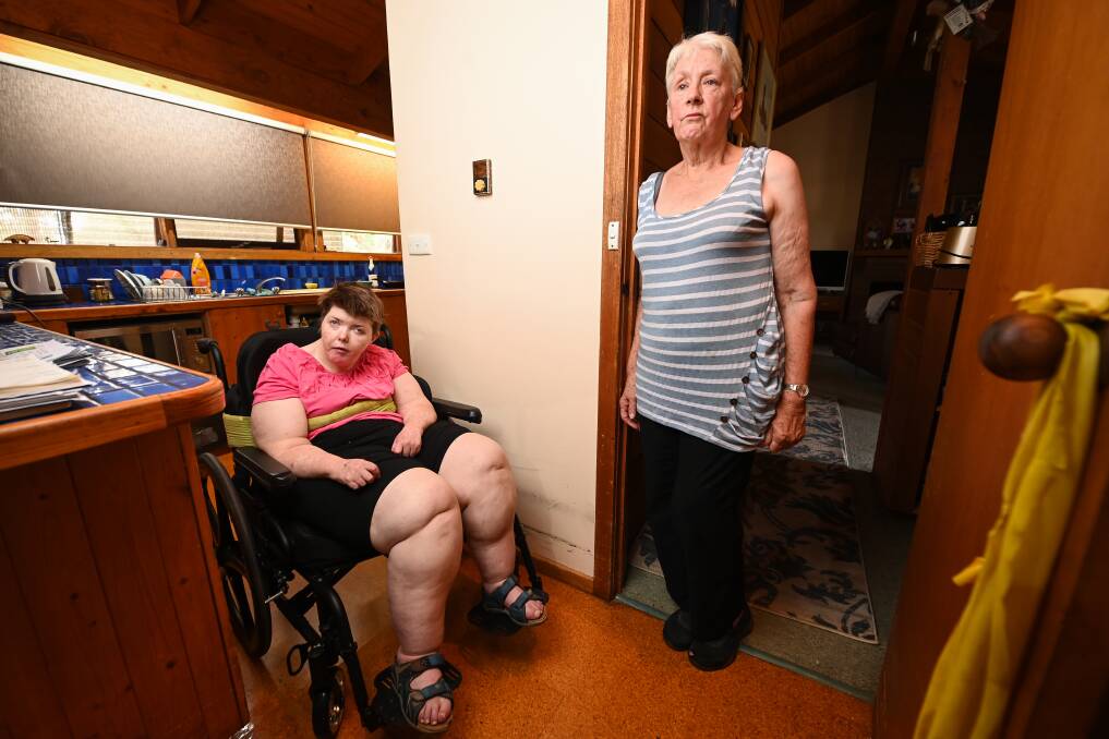 Melanie, with her mum and carer, Kay Ruggi shows the struggles it takes to move Melanie around their current house in Beechworth, which has put scuff marks on the walls from the wheelchair. Picture by Mark Jesser