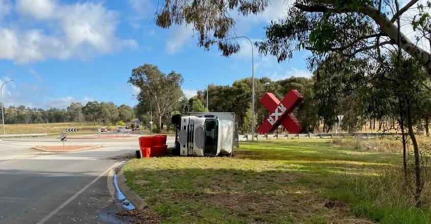 The truck rolled just north of Albury, the driver was not injured. Pictures supplied by Fire and Rescue NSW