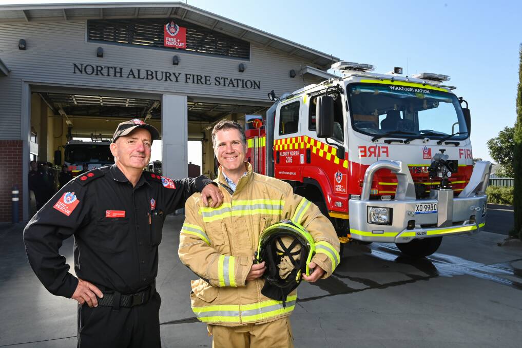 Captain Andrew Schneider and Albury MP Justin Clancy in front of the new half-million dollar truck that Mr Clancy offically handed over. Pictures by Mark Jesser