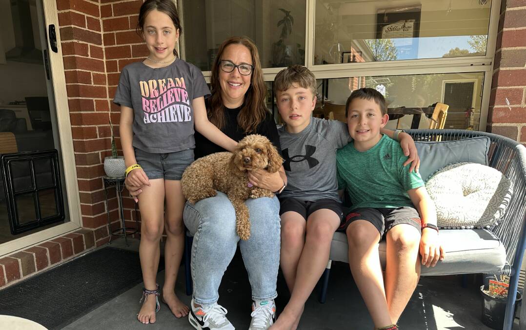 Luisa Corrigan with her children Madeline, 8, Max, 10, and Thomas, 8, with Ruby their dog. She says Max's diagnosis has been "hard" but the family has stuck together through the highs and lows. Picture by Sophie Else