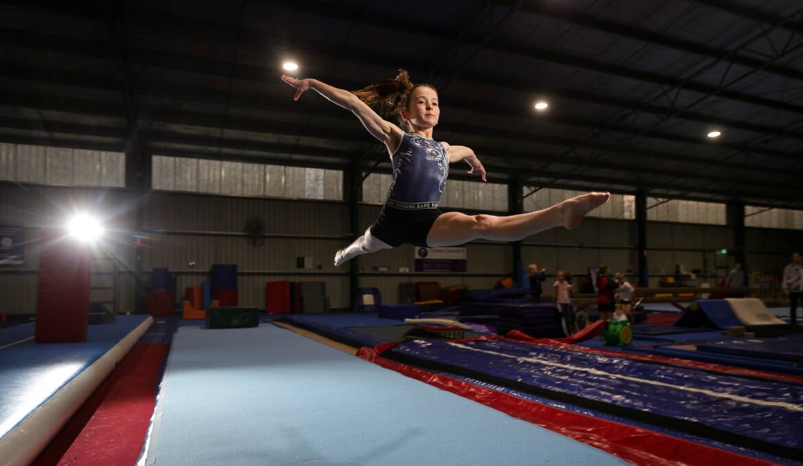 Ruby Kelly gets airborne at Flyaway Gymnastics. Picture by James Wiltshire
