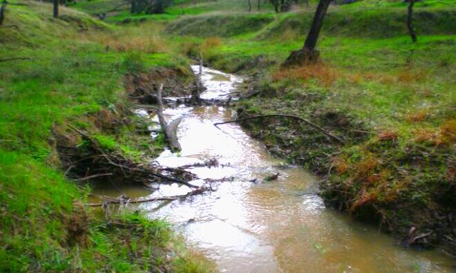 The creek that flows into Sunday Creek from the Lake Moodemere Estate property, pictured after 22 millimetres of rain. Picture by Peter Twigg