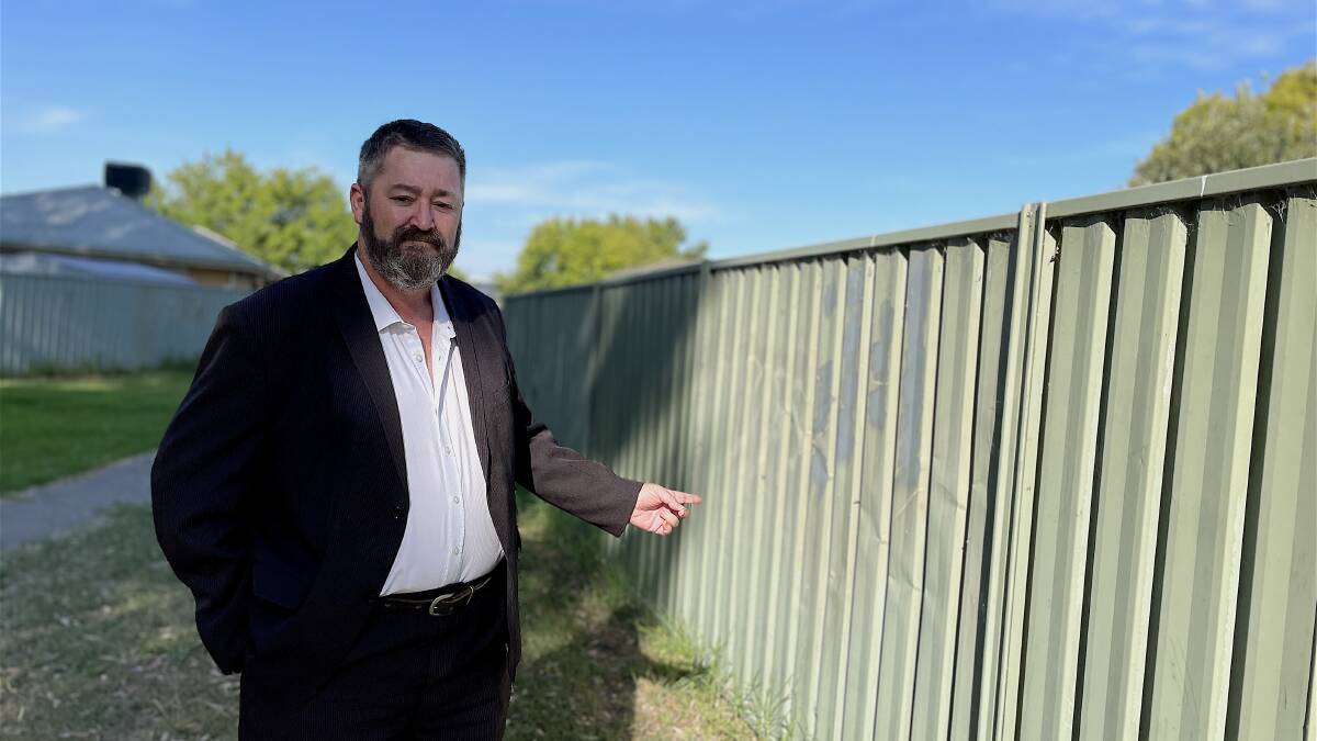 The damaged fence which divides the drain reserve from a housing complex is often "kicked in for fun" late on Friday and Saturday nights. Picture by Ted Howes 