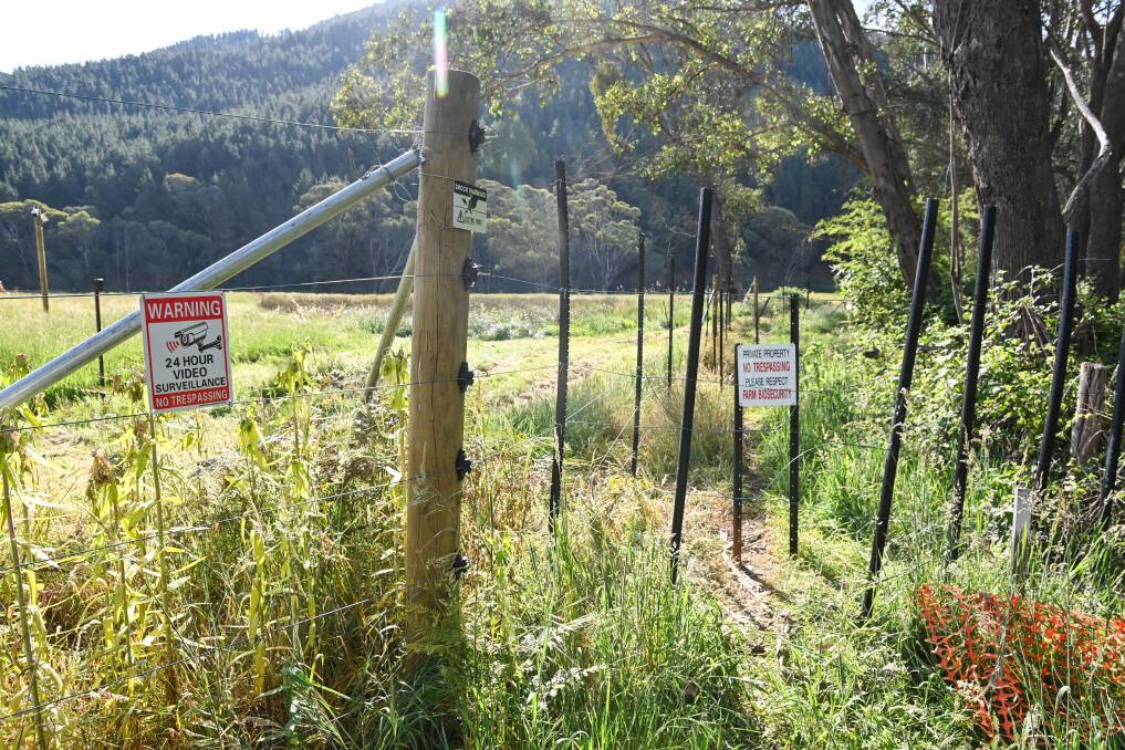 Signs warn walkers of the dangers of the electric fence barring people from venturing further down the historic track. Picture by Mark Jesser
