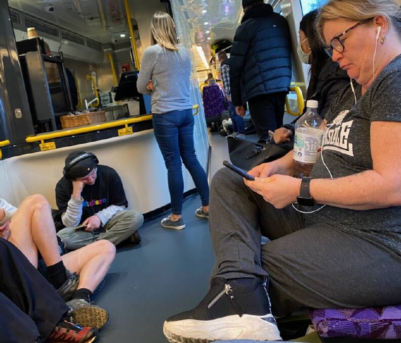 Dozens of passengers take up any space they can find around the cafeteria of a V/Line train as it makes its way to the North East from Melbourne. Picture supplied