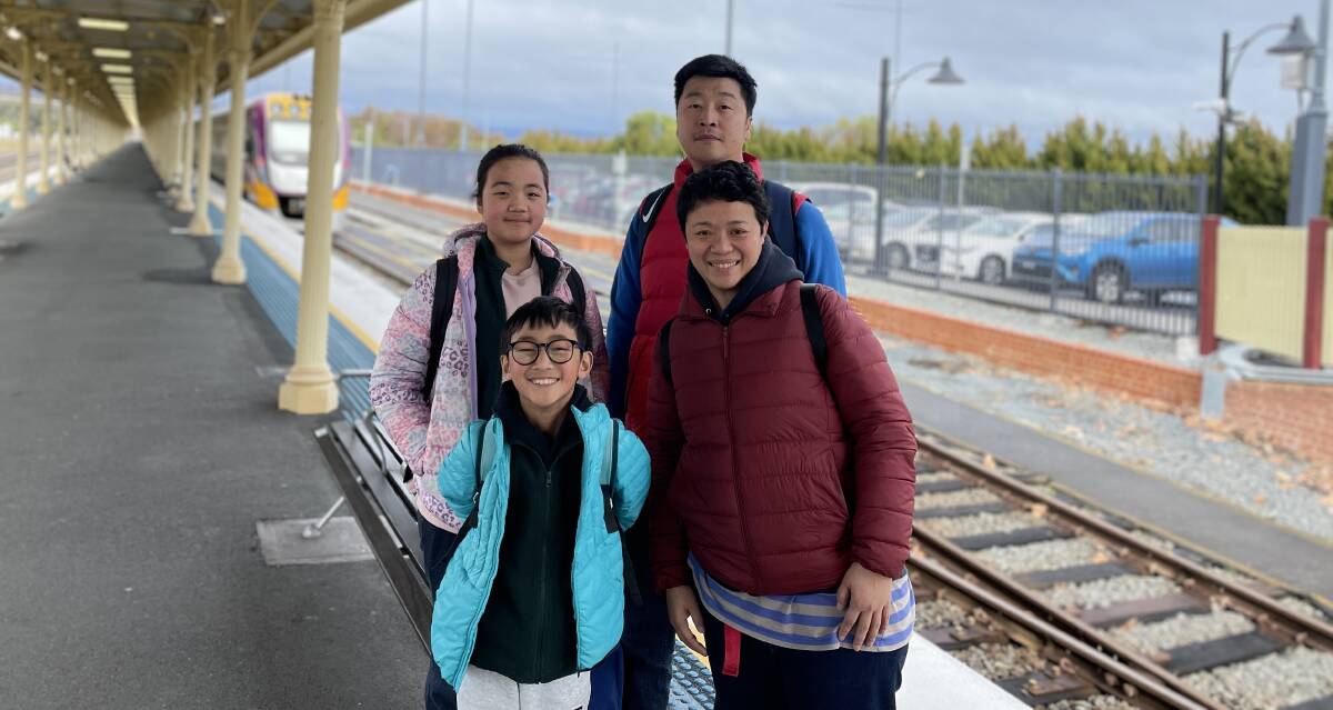 Daytrippers Venus and Harris Wong, left, Paul Wong and Sam Lo were happy the cafe was operating on the train from Melbourne to Albury on Saturday, July 8. The car park behind was filled to capacity. Picture by Ted Howes