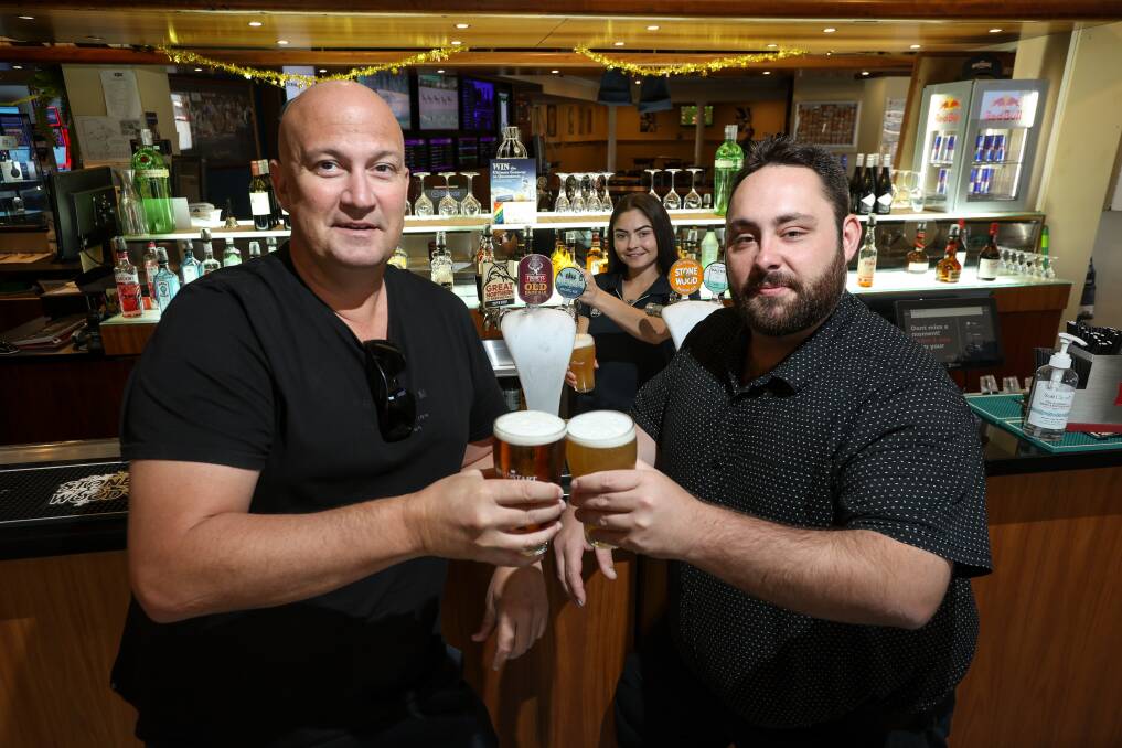 Northside Hotel regular Daniel Anderson toasts the ongoing renovations with general manager Nathaniel McPhee after bar staff member Djanarah Delphin-Kennedy poured them a beer. Picture by James Wiltshire
