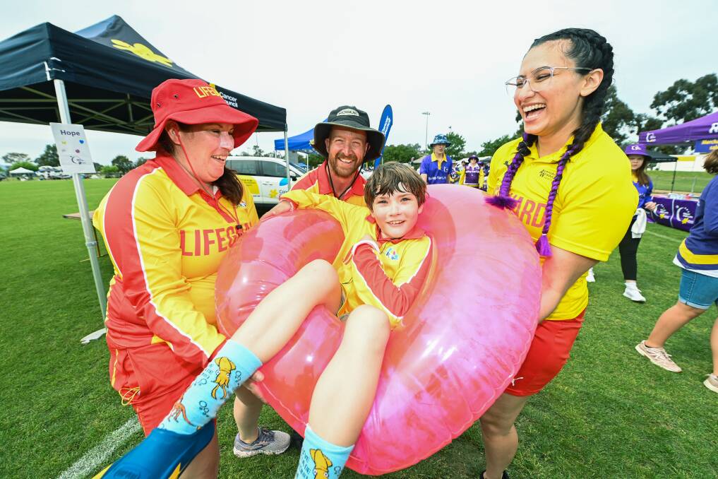 Albury Wodonga Aquatics team Cooper Houghton, 9, with Nicole Reeves, Matt Vyner and Emma Dennis at Relay for Life. Picture by Mark Jesser