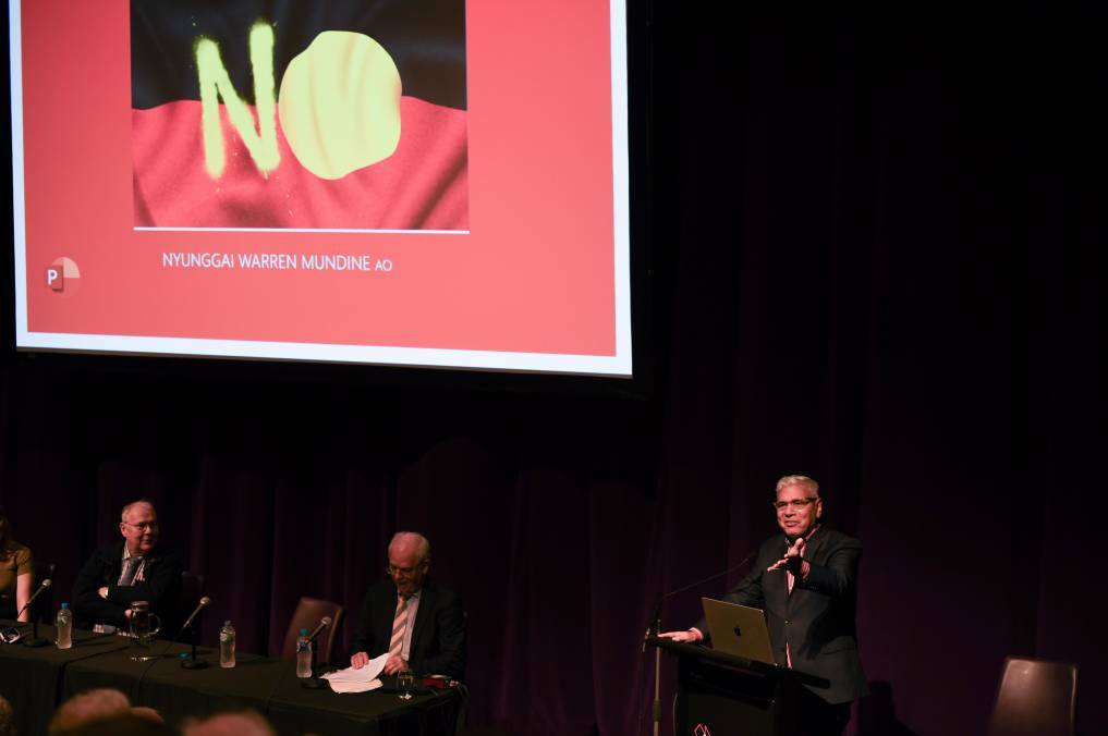 Warren Mundine speaks to the audience from a lectern at The Cube in Wodonga as National Civic Council members watch on. Picture by Tara Trewhellla
