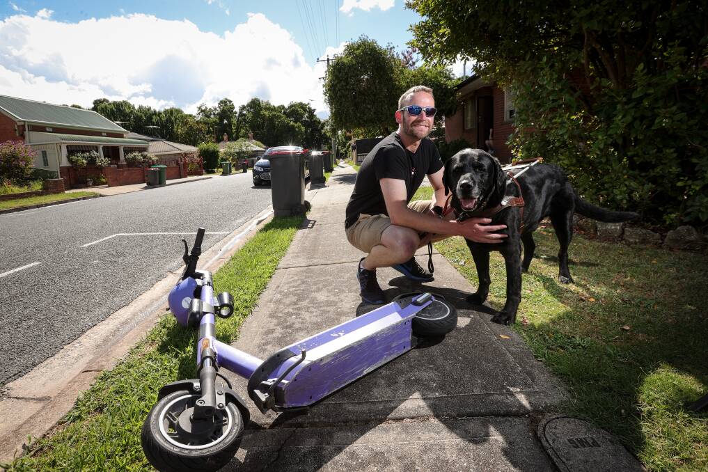 Daniel Searle, pictured with his guide dog, Frodo, says he would like to see Albury's e-scooter initiative scrapped and more money spent on bike lane infrastructure and public transport. Picture by James Wiltshire