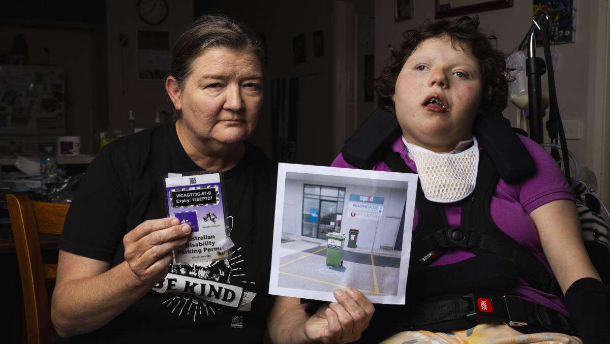 Shirley McKernan and her 16-year-old daughter Matilda Maxfield were blocked from a disabled parking space at Wodonga Place by a wheelie bin. Picture by Ash Smith