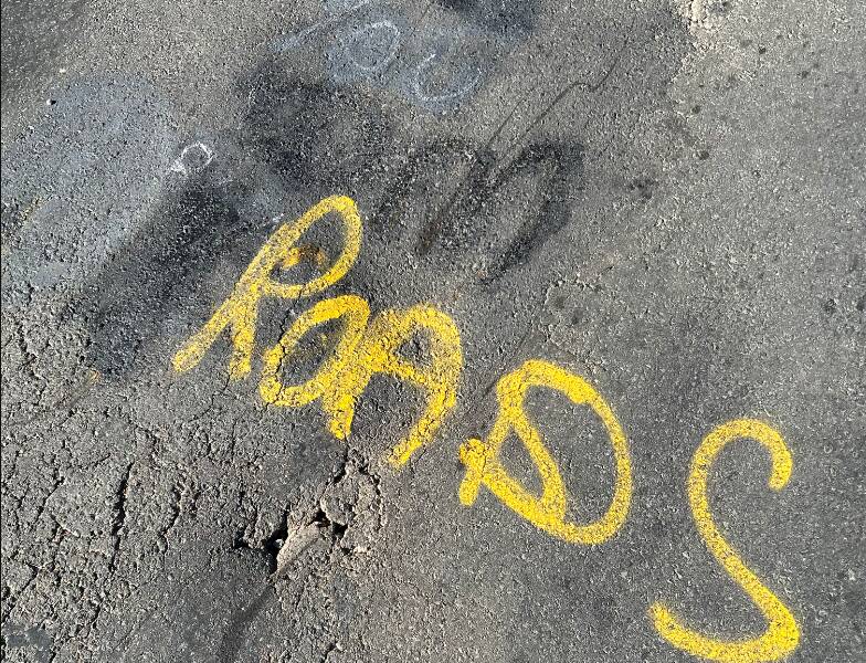 Graffiti on Wangaratta-Yarrawonga Road near Bundalong, just metres from a damaged section of bitumen described as "extremely dangerous. Pictures supplied