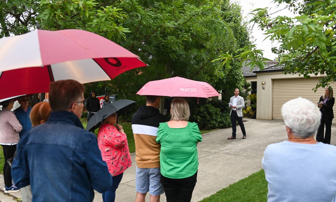 Auctioneer Nicholas Clark at the East Albury home on Kookaburra Way says crowds are slowly returning to auctions after a month-long break. The property sold after auction for $695,000. Picture by Mark Jesser 