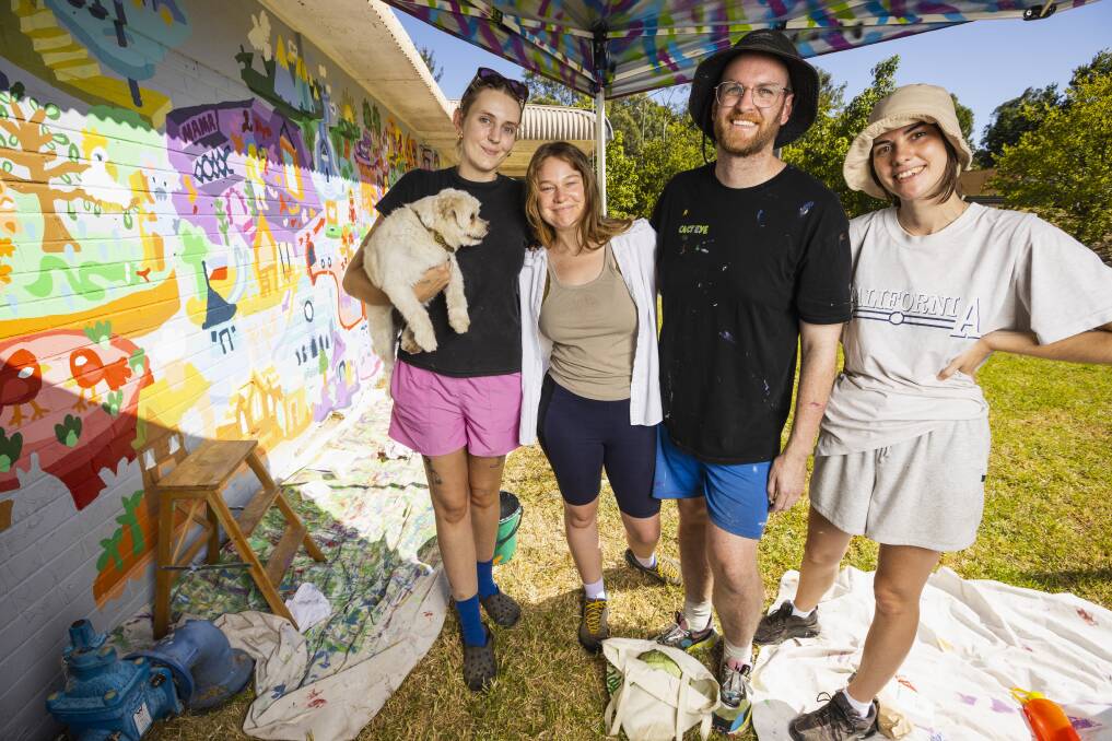 Artists Lauren Brown, Sophia Smithwick, Jeff McCann and Elynor Smithwick on day eight of painting McCann's Albury World mural at the Albury Swim Centre. Picture by Ash Smith.