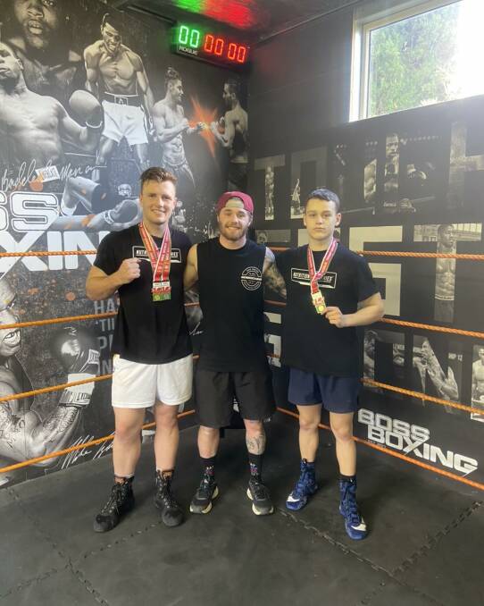Boss Boxing gold medal winners Jason O'Rourke (left) and Jake Hruz (right) alongside coach Corey Pyle. They are back on home soil and right into training for the next event.