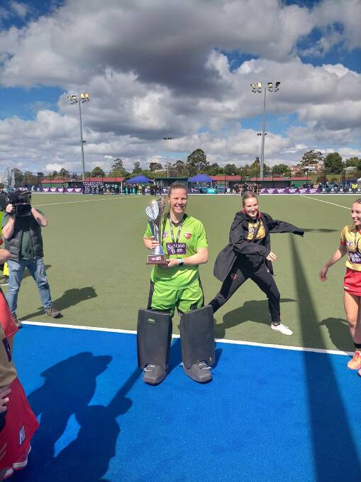 Albury's Jocelyn Bartram hoists the Hockey One trophy after sealing the National Championships with NSW Pride. She starred in a gripping shootout triumph over Brisbane Blaze in the grand final on Sunday afternoon