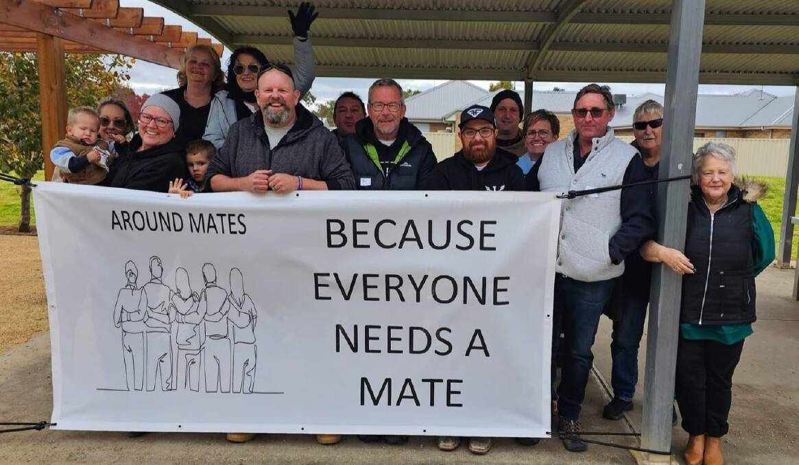 Scott Vesty (centre left) and the crew from Around Mates at one of their BBQs. Picture supplied