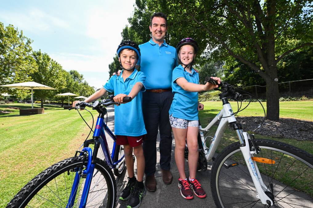 Ben Fryer with his daughter Edie Fryer, 9, and Fraser Green, 9. Picture by Mark Jesser