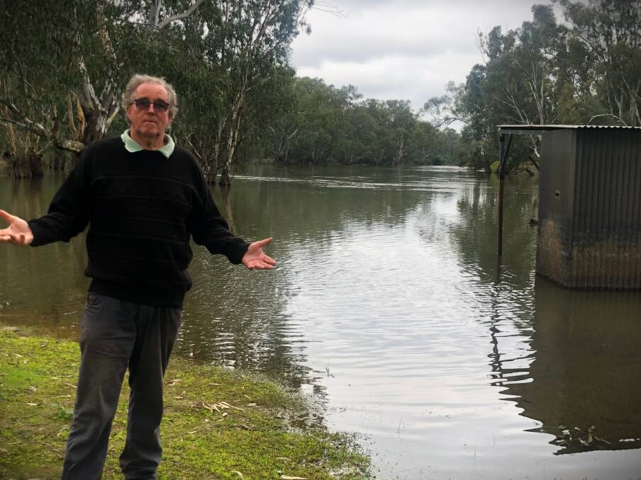 Richard Sargood standing next to the Murray River with a flow of about 35,000 megalitres a day. He said "this is what will happen if they try and force these extra flows down the river". Picture supplied