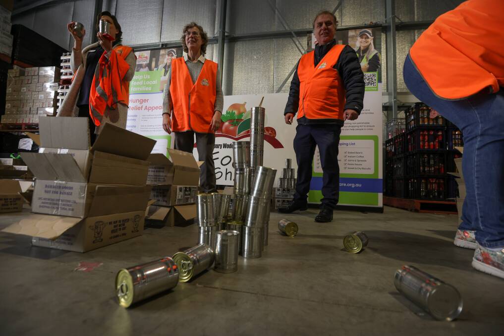The Border Mail's Janet Howie and Anthony Bunn with their can tower. Picture by James Wiltshire