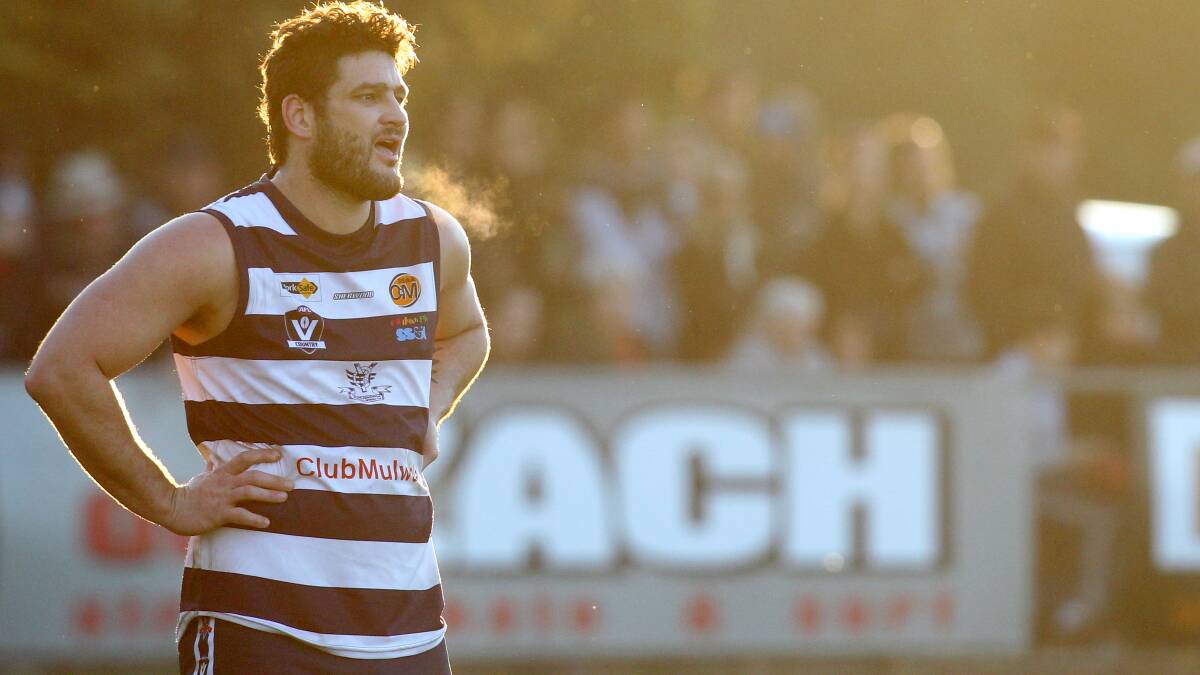 Brendan Fevola in Pigeons' colours at a cold J.C. Lowe Oval in June, 2013.
