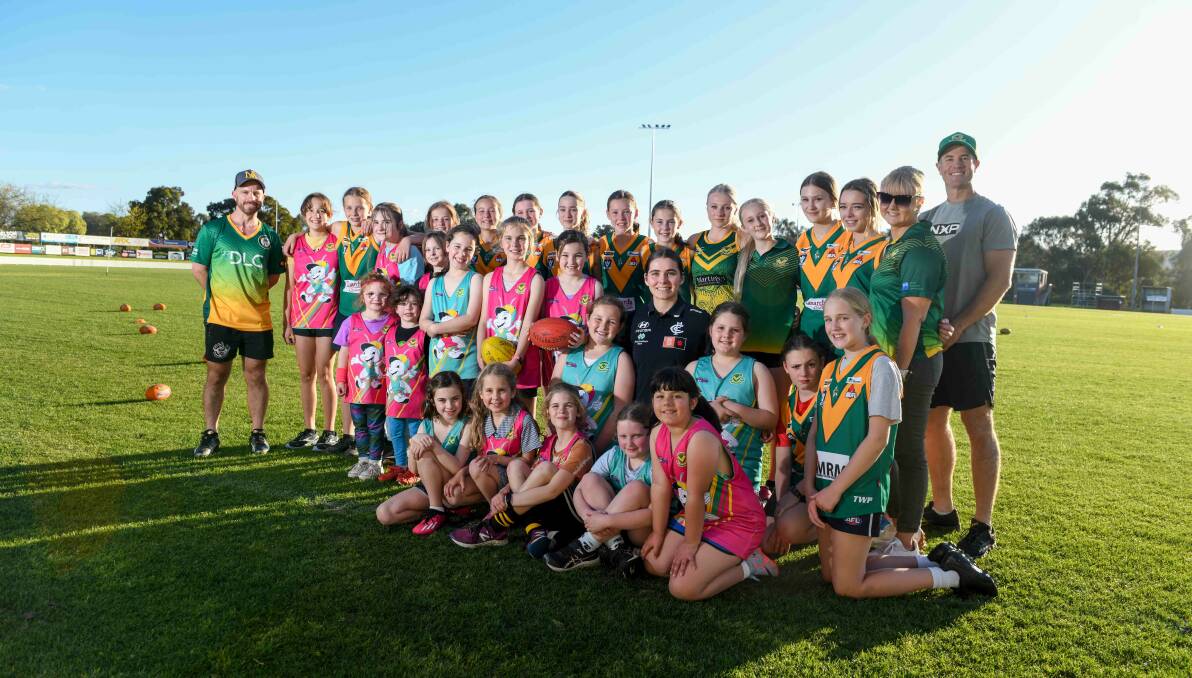 Carlton AFLW player Maddy Guerin with North Albury's junior footballers following training. Picture by Tara Trewhella.