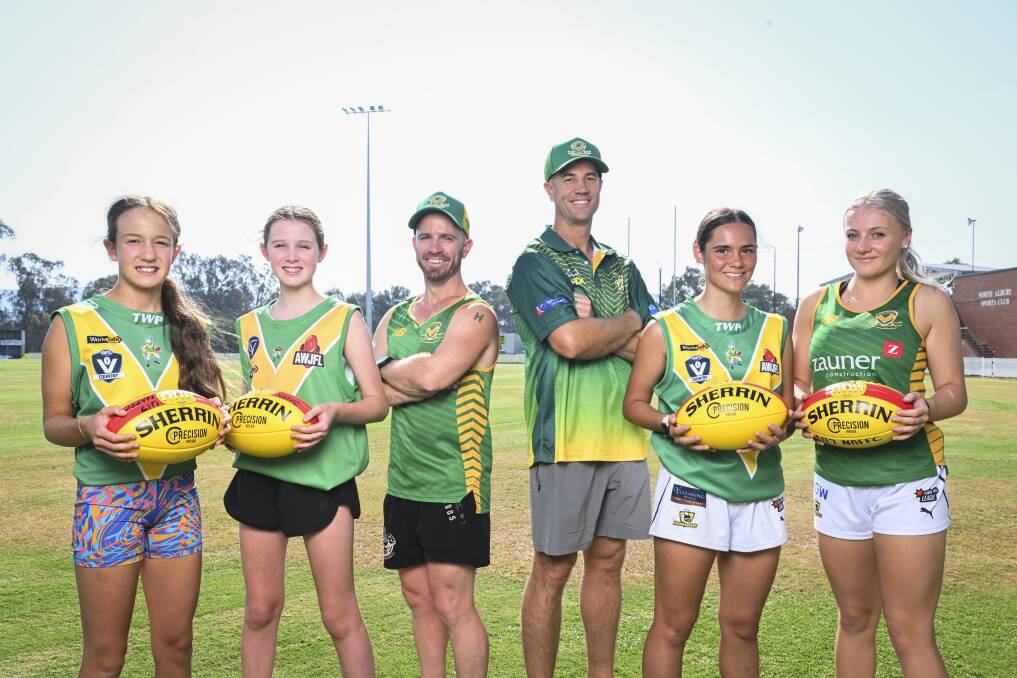 Mae Bassingthwaighte, 12, Penelope Tari, 12, coaches Nick McDonald and Dean Hopwood, Ruby Heinrich, 15 and Chelsea Hopwood, 15 are ready to join the AFL NEB Female Football League. Picture by Mark Jesser