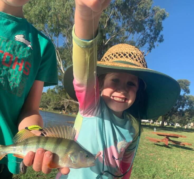 GOING SOLO: Imogen Rahaley, 5, with a redfin she caught on a worm all by herself. Reports of reddies in the shallow waters are common right now, with yabbies and worms tempting good numbers of fish.