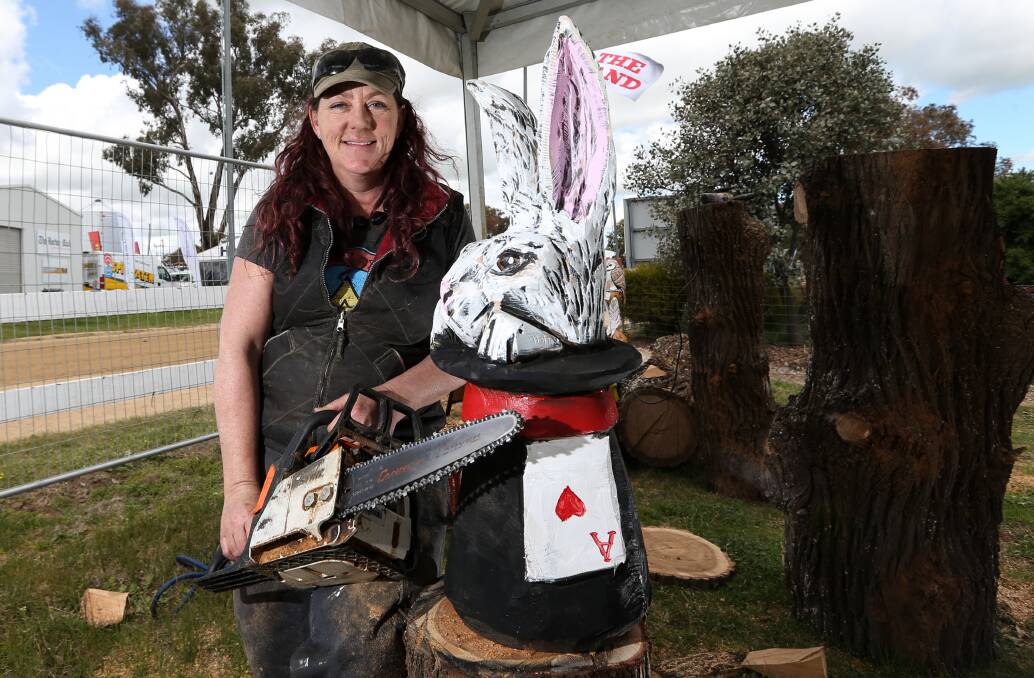 ART: Sculptor and power carver Angie Polglaze with one of her colourful animal creations.