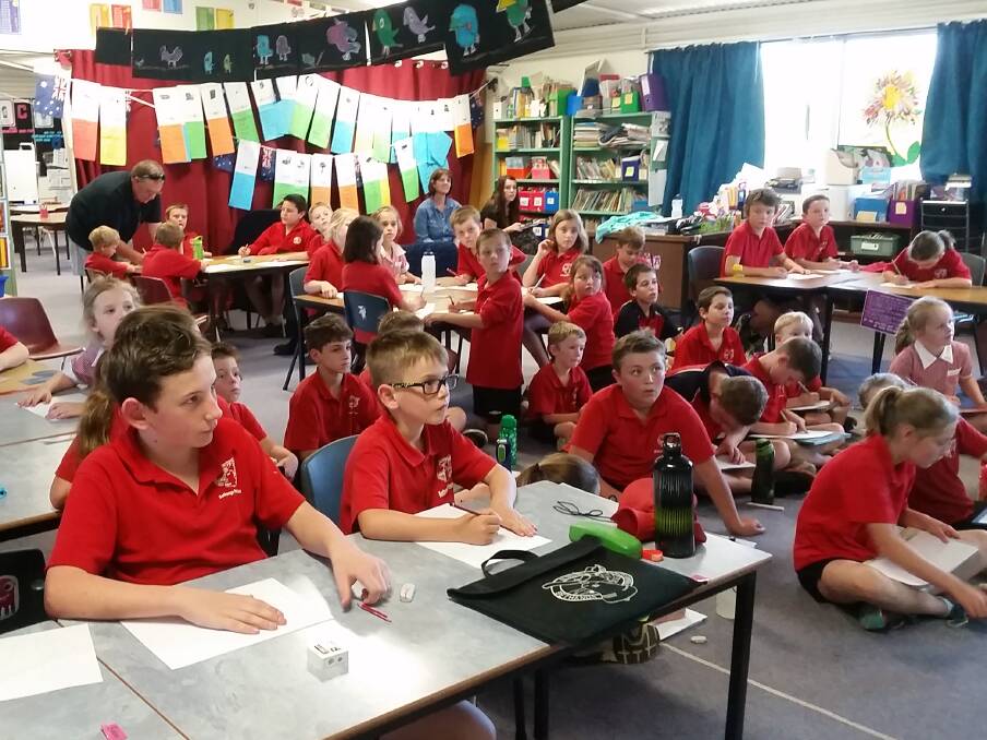 Students at Bethanga Primary School listen on in fascination to author Kim Macklin talk about her new book and character Brewster the Bulldog.