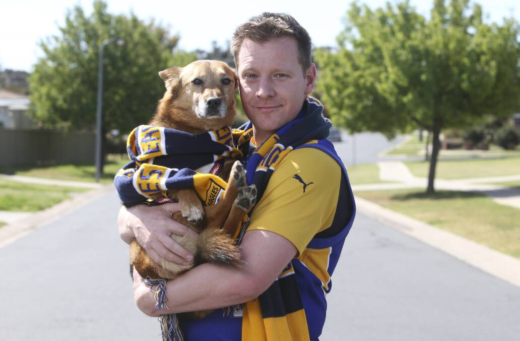 PROUD FAN: West Coast Eagles supporter Jayson Reilly, from Wodonga, with his dog Charlie in team colours ahead of the AFL grand final. Picture: ELENOR TEDENBORG