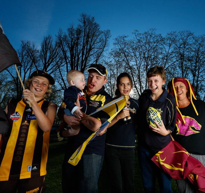 FLYING HIGH: Euriah Holland, 11, Ben Ward and daughter Violet, 7 months, Cowboys fans Adrienne and Taylah Hartnett, 14, and Renae Mason, of Wodonga, display their colours ahead of the grand finals. Picture: MARK JESSER
