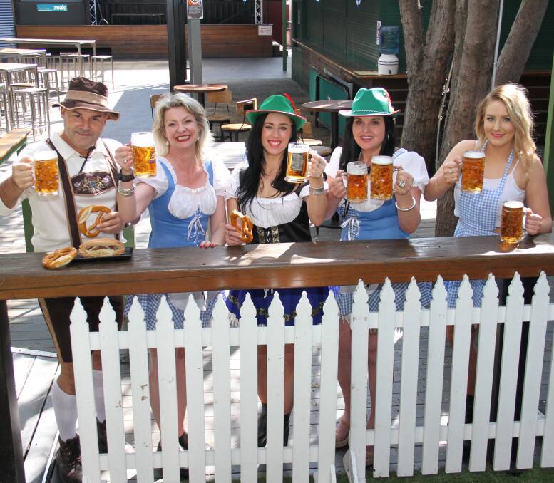 GUTEN TAG: Dan Sawyer, Kate Spendier, Steph Carroll, Jodie Tiernan and Rachel Javens with the steins and food which will be available to revellers who enjoy Oktoberfest celebrations on October 17.  Picture: DAVIS HARRIGAN