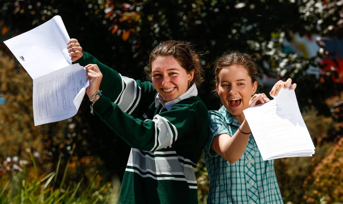 RIP IT UP: Beechworth Secondary College Year 12 students Riannon Garvey and Nicole Clark, both 17, are excited to let go of their English examination paper after they wrote for three hours on Wednesday. Pictures: MARK JESSER