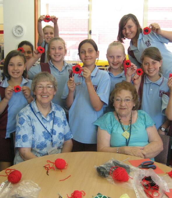 POPPIES: L-R: Students Lilly Murtagh, 10, Isabella Wheatley, 11, Isabelle Smillie, 9, Sophie Barrett, 10, Michaela Binyon and Hannah Baldock, 11, Olivia Missen, 10, and Zara Johnston, 12 with mentors Ruth Corbett and Tolarna Hurle (front).