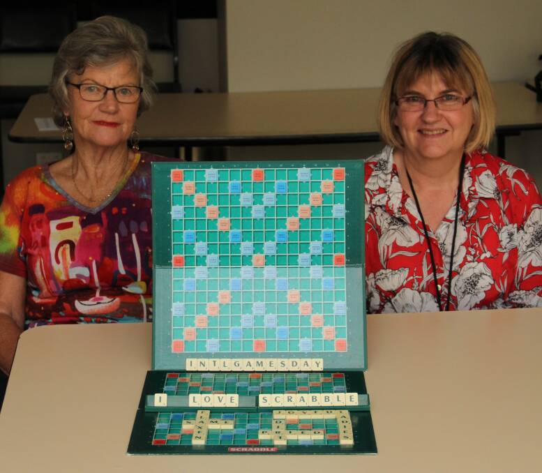 WORD MASTERS: Robin Elliott and Ruth Grogan, of the Wodonga Scrabble Club, enjoy a bit of light-hearted relaxation at their regular meeting, waiting for International Games Day on Saturday. Picture: DAVIS HARRIGAN