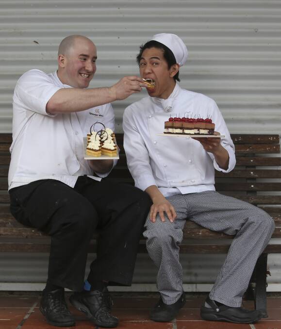 HIGH TEA: Albury's Geoffrey Michael hams it up with TAFE Certificate III in Patisserie student Jerome Vibas during a break from the high tea luncheon in Wodonga, which attracted 80 people on Tuesday. Picture: ELENOR TEDENBORG