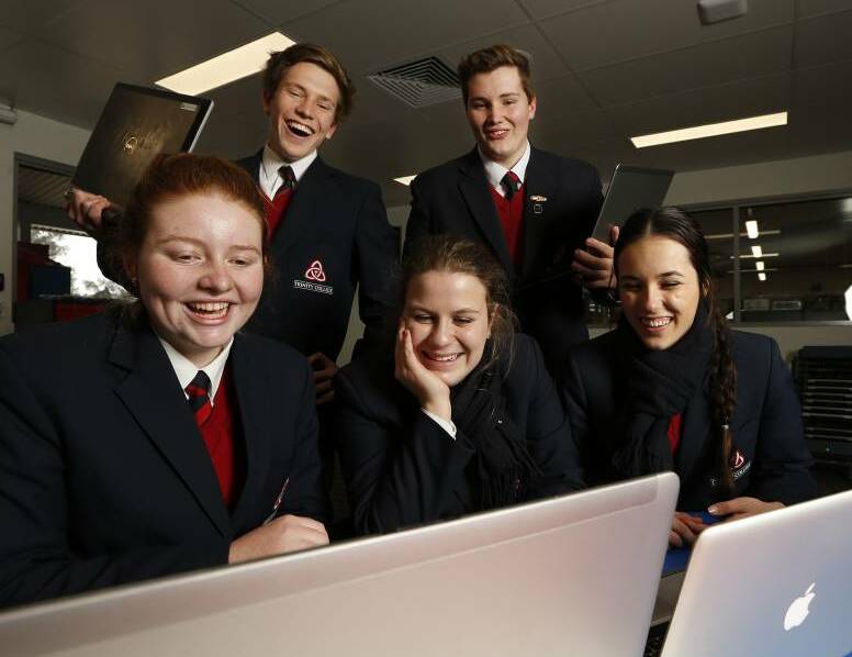 TECHNOLOGY ADVANCEMENT: Trinity Anglican College students Kaitlyn Wheeler, 17, Bailey Waters, 16, Mia Zitzlaff, 17, Jake Dicketts, 17, and Shannon Fenn, 17, look at their laptops. Picture: MARK JESSER.